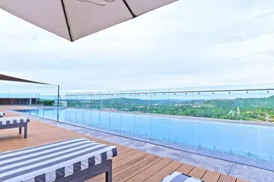 a large swimming pool on top of a building at Luxury 1 bedroom apartment in vibrant Menlyn Maine in Pretoria