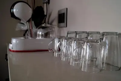 a row of empty glasses sitting on a counter at Luxury 1 bedroom apartment in vibrant Menlyn Maine in Pretoria