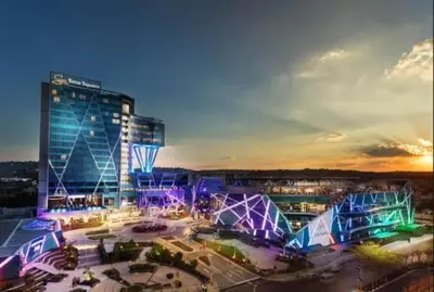 a large building with a lot of lights in front of it at Luxury 1 bedroom apartment in vibrant Menlyn Maine in Pretoria