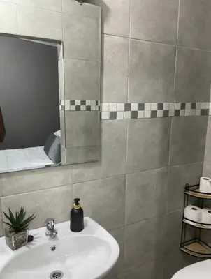 a bathroom with a sink and a mirror at Solace Unit in Phalaborwa