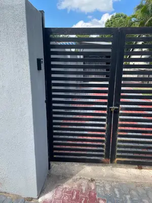 a door to a building with a metal gate at Solace Unit in Phalaborwa