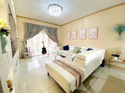 a living room with a white couch and a bed at Siena Sun Luxury Suite 1 in Midrand