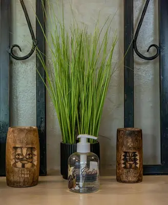 a group of four vases with plants in them at Hoedspruit Bush Cottage in Hoedspruit