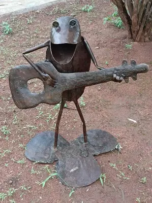 a metal statue of a bird holding a gun at Hoedspruit Bush Cottage in Hoedspruit