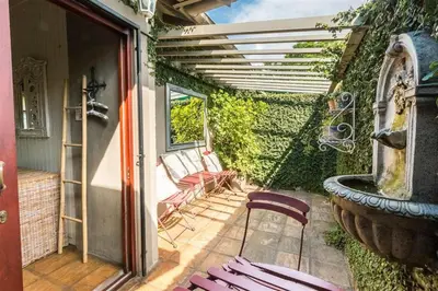 a patio with two chairs and a fountain at Ambiance Guesthouse in Pretoria