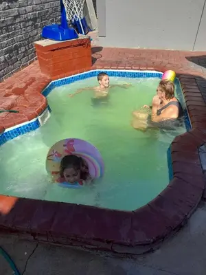 a group of children playing in a swimming pool at Cozy guesthouse springs in Springs