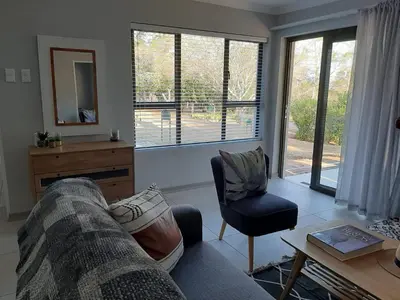 a living room with a couch and a chair at The Bird Hide Luxury Self catering Chalets in White River