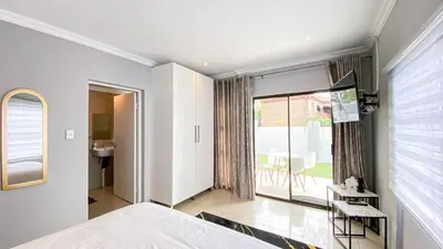 a bedroom with a bed and a large window at Midrand Air B and B House in Midrand