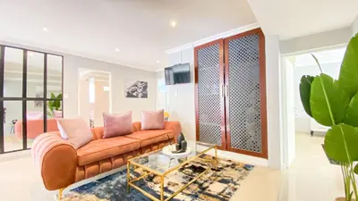 a living room with a couch and a glass table at Midrand Air B and B House in Midrand