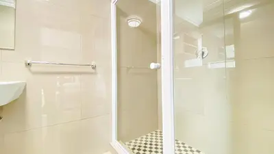 a shower with a glass door in a bathroom at Midrand Air B and B House in Midrand