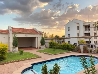 a villa with a swimming pool and a house at Midrand Air B and B Apartment in Midrand