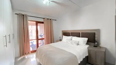 a bedroom with a large bed and a window at Midrand Air B and B Apartment in Midrand