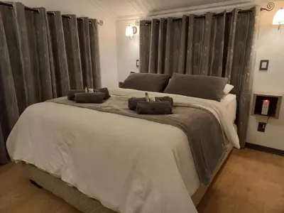 a bedroom with a large bed with two towels on it at Cosy Corner in Kampersrus AH