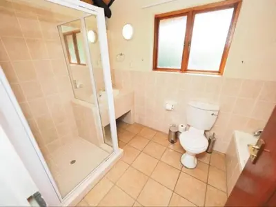 a bathroom with a shower and a toilet and a sink at Kruger Park Lodge Unit 550 With Private Pool in Hazyview