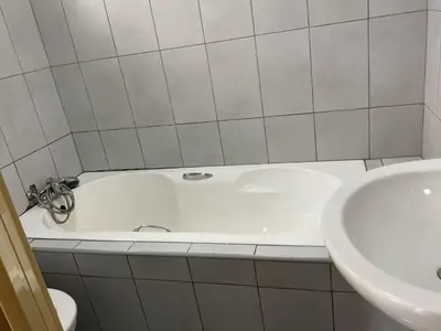 a bathroom with a white tub and a sink at northmead lodge in Benoni