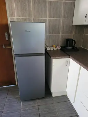 a white refrigerator in a kitchen next to a counter at 29B Zebra Street - InHimwe Guesthouse in Polokwane
