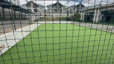 a view of a baseball field from behind a net at Fealathome Apartment in Midrand