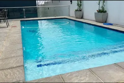 a large blue swimming pool in a building at Nid de Rêve Accommodation in Midrand