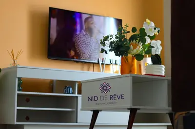 a living room with a tv and a white dresser at Nid de Rêve Accommodation in Midrand