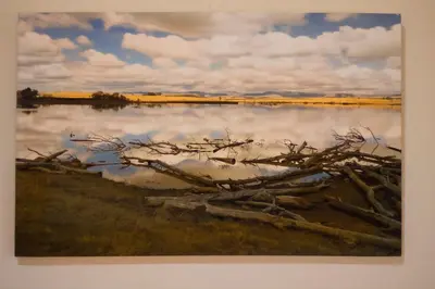 a painting of a lake with clouds in the water at Oude Post Guesthouse and Cottage - The Old Postmaster's House in Lydenburg