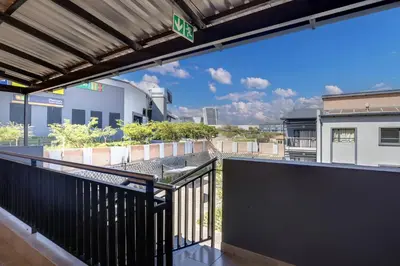 a balcony with a view of a building at Opposite Mall of Africa Inn in Midrand