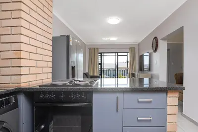 a kitchen with a counter top and an oven at Opposite Mall of Africa Inn in Midrand