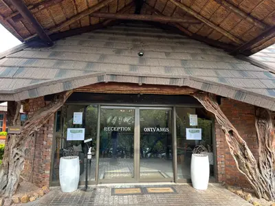 an entrance to a store with a glass door at Pumula Bush Chalet in Mabula