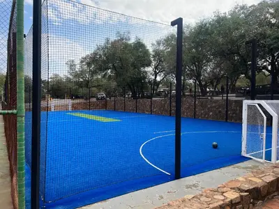 a basketball court with a net and a ball at Pumula Bush Chalet in Mabula