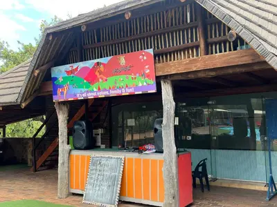 a building with a sign in front of it at Pumula Bush Chalet in Mabula