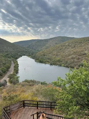 a view of a river from a viewing deck at Pumula Bush Chalet in Mabula