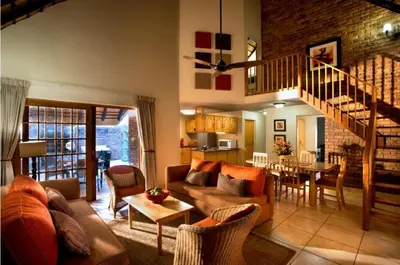 a living room with a couch and a table at Kruger Park Lodge unit 34 in Hazyview