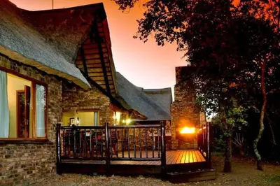 a house with a gate in front of a building at Kruger Park Lodge unit 34 in Hazyview