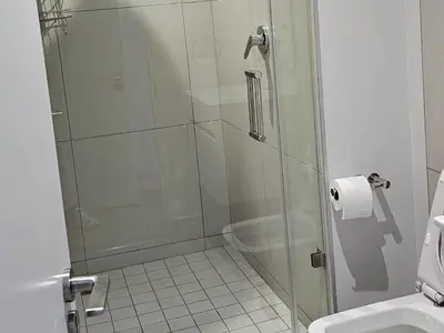 a shower with a glass door in a bathroom at Ellipse Waterfall Luxury Apartments in Midrand