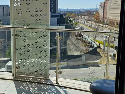 a glass window with a view of a skate park at Ellipse Waterfall Luxury Apartments in Midrand
