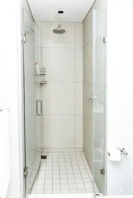a shower with a glass door in a bathroom at Ellipse Waterfall Luxury Apartments in Midrand