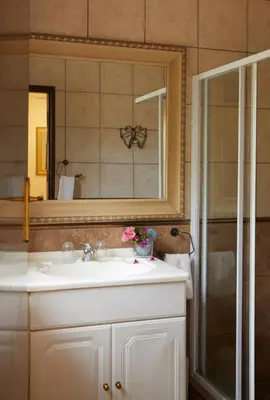 a bathroom with a sink and a mirror at Villa Ticino Guest House in Sabie