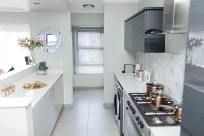 a kitchen with white counters and a stove top oven at Fore's Luxurious Home in Midrand