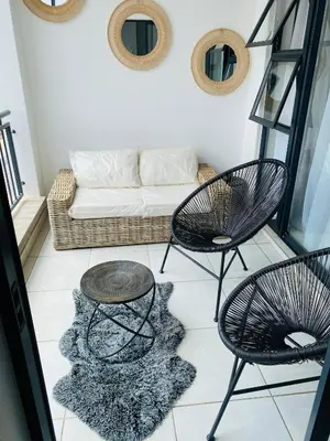 a living room with two chairs and a couch at Luxury beach lagoon 1 Bedroom apartment in Pretoria