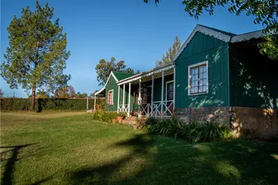 a green house with a yard in front of it at Machado Stay Pecan Cottage 1 in Machadodorp