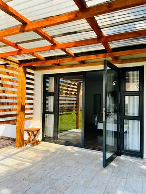 an open patio with glass doors and a wooden ceiling at Modern studio apartments in Secunda