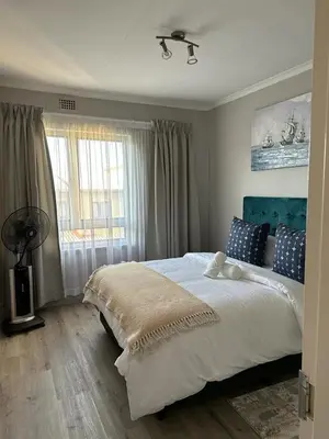 a bedroom with a large bed and a window at Air bnb 204 in Midrand
