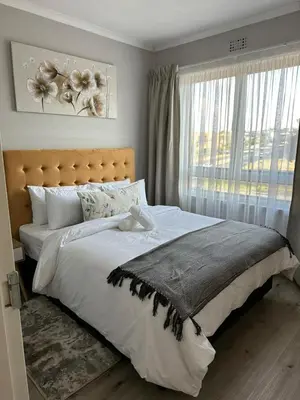 a bedroom with a large bed and a window at Air bnb 204 in Midrand