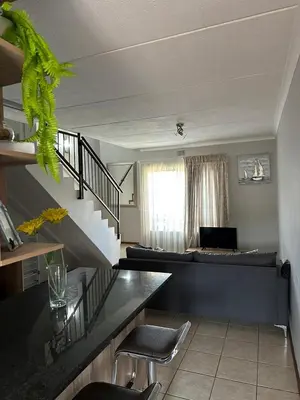 a living room with a couch and a table at Air bnb 204 in Midrand