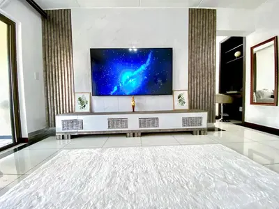 a living room with a flat screen tv on a wall at Siena Sun Luxury Suites 5 in Midrand