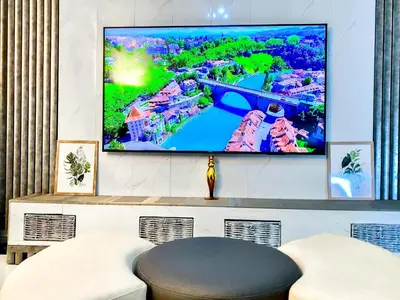 a living room with a flat screen tv on a wall at Siena Sun Luxury Suites 5 in Midrand