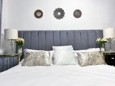 a bedroom with a bed with white sheets and pillows at Siena Sun Luxury Suites 5 in Midrand