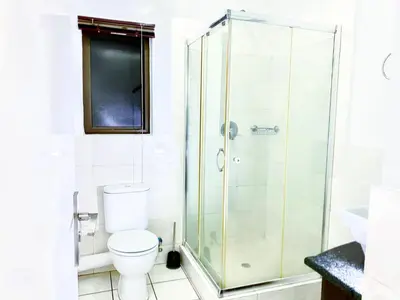 a bathroom with a shower and a toilet at Midrand Siena Sun Luxury Suites 3 with water reserve in Midrand