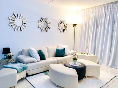 a living room with a couch and a table at Midrand Siena Sun Luxury Suites 3 with water reserve in Midrand