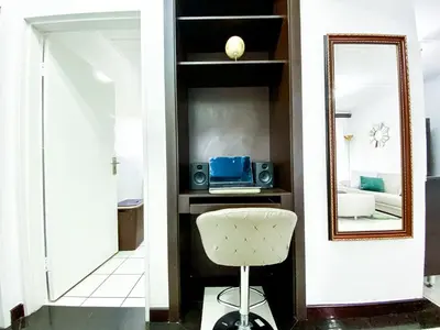 a living room with a mirror and a chair at Midrand Siena Sun Luxury Suites 3 with water reserve in Midrand