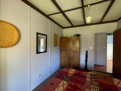 a room with a bed and a mirror on the wall at Thathe Dam Lodge in Vhutandabos